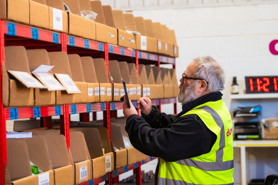 Reilly's warehouse team picking and scanning stock