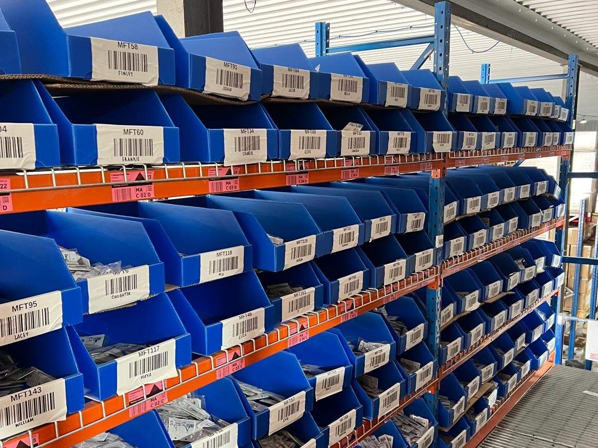 Personalised merchandise organised in labelled bins ready for pick and pack