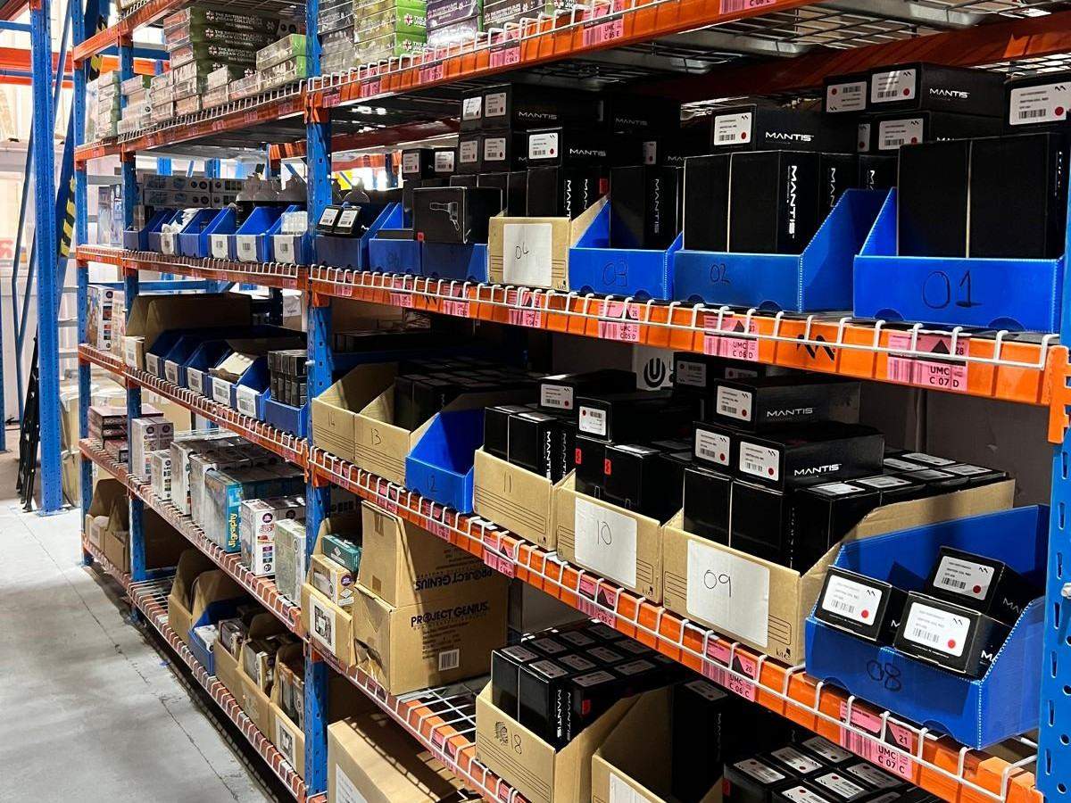 Sports and leisure equipment stored on warehouse shelving ready for despatch